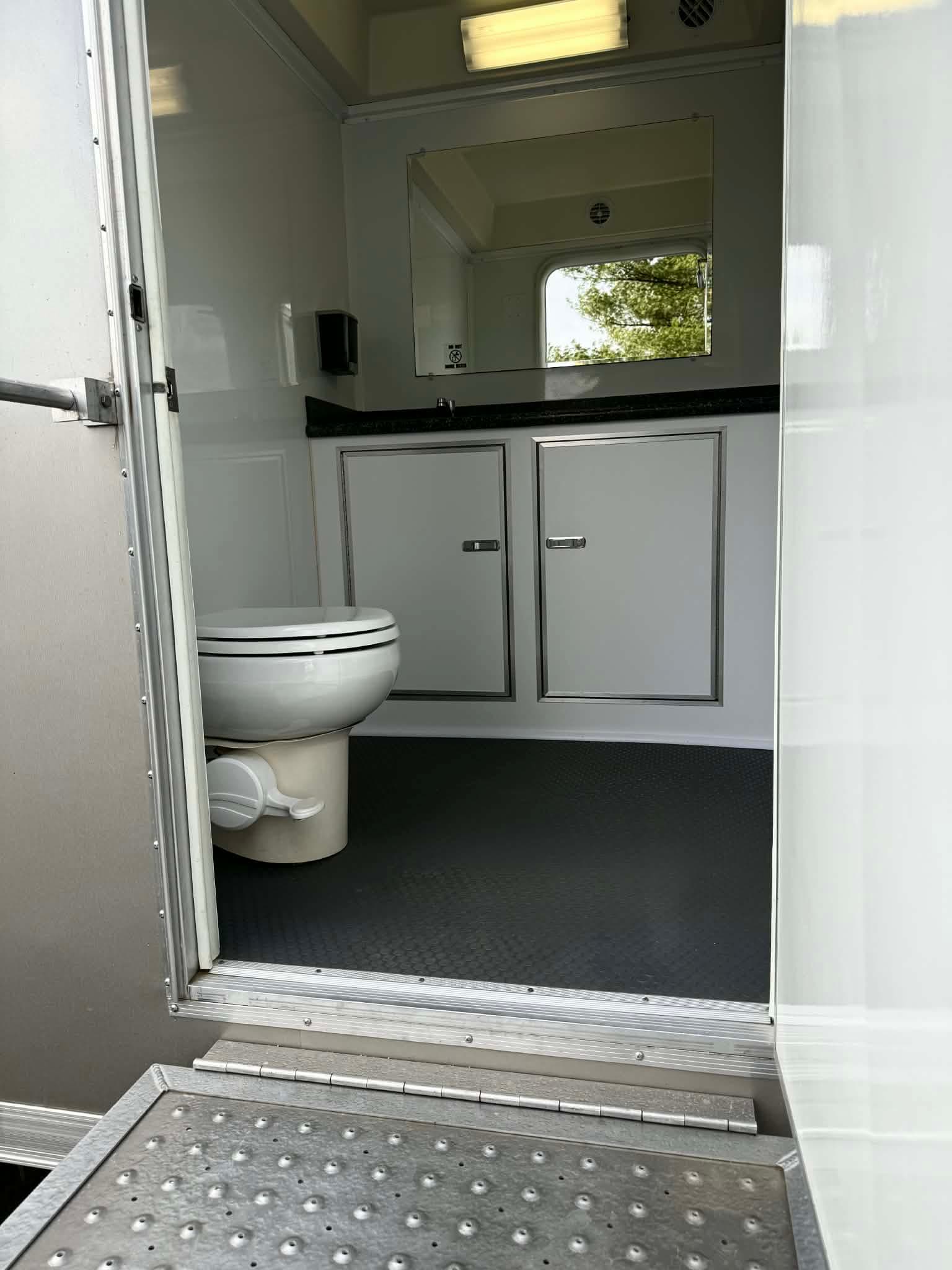 Private two-stall suite interior with vanity and mirror